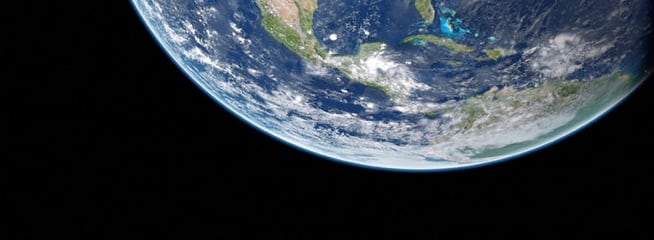 Deep Earth – A stunning cosmic view of Earth from space, showcasing its vibrant blues and swirling clouds against the vast darkness.