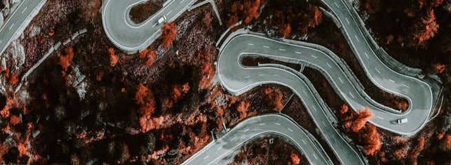 From Up Above VR – An aerial view of a winding road winding through the landscape.